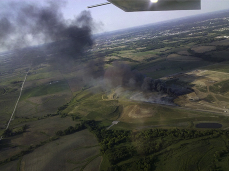 smoke rising, 100s of feet, aerial photo of green fields